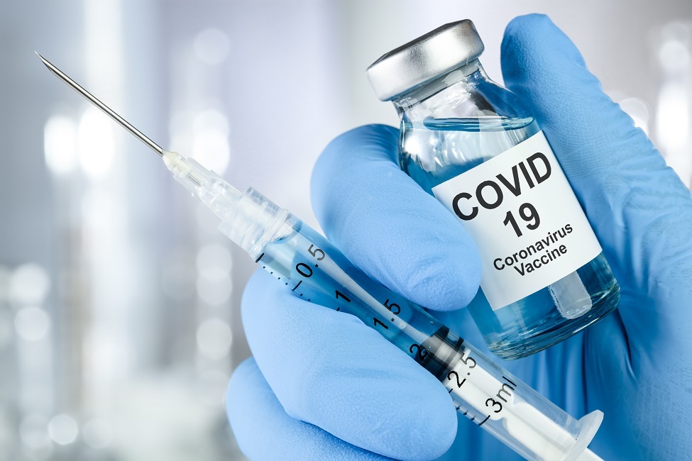 Image of needle and COVID vaccine 