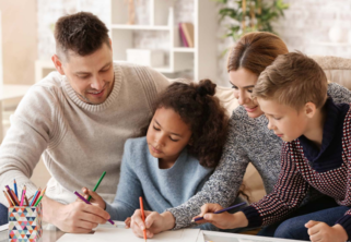 Parents review homework with daughter. 