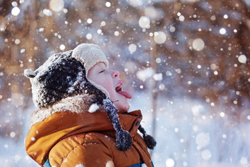 child catching snowflakes