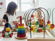 Toys in an early learning setting and children in the background
