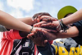 Youth put their hands together in show of unity. 