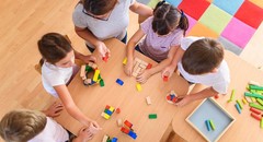 A group of children playing with blocks on a table at daycare