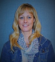 Photo of DeEtte Snyder, smiling at the camera, wearing a colorful scarf and jean jacket.