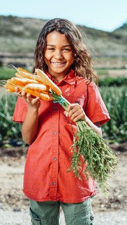 child holding carrots