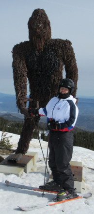 Picture of Jose skiing next to a big foot sculpture