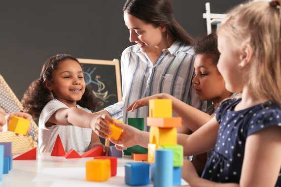 Young children playing with colorful blocks