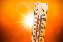 Thermometer with high temperature and red/orange background to emphasis hot