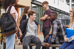 Youth in school talking in a courtyard