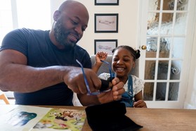 Father cleaning daughter's eyeglasses