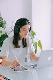 woman on a laptop with headphones