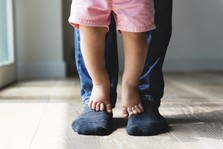 child feet and caregiver