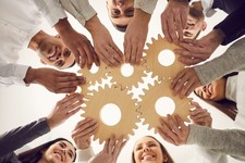 Group of people in a circle holding fitting puzzle pieces