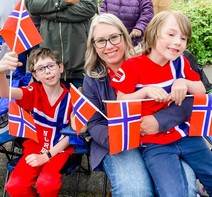 Photo of Katie Long and her two young sons smiling at the camera.