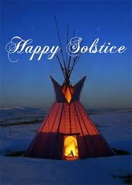 Happy Solstice: Photo of a warm, cozy teepee, glowing from the inside by a fire, as it’s surrounded by blue twilight and a snowy vast landscape. 