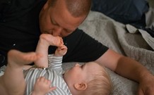 dad kissing babies feet