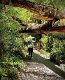 photo of a mom carrying her son on her back through the wilderness