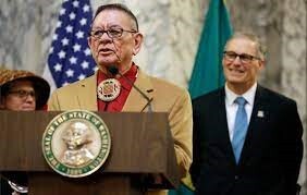 Former Sen. John McCoy, D-Tulalip, left, speaks Wed., Feb. 22, 2017, as WA Gov. Jay Inslee, looks on, at the Capitol in Olympia, WA. 