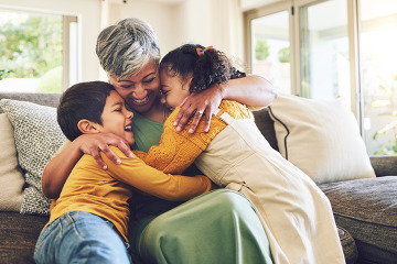 Children hugging grandma