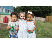 Three children playing in backyard.