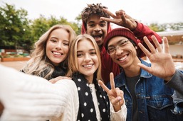 Teens smiling while taking a selfie