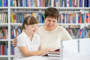 adult and child reading in library
