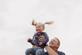 Father lifting a child.