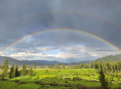 photo of yellowstone national park scenery of a double rainbow 