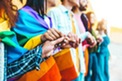 Group of lgbt people holding hands outside - Diverse happy friends hugging outdoors