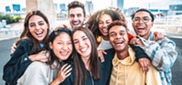 Happy group of young people smiling at camera outdoors 