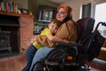 Woman on wheelchair hugging son
