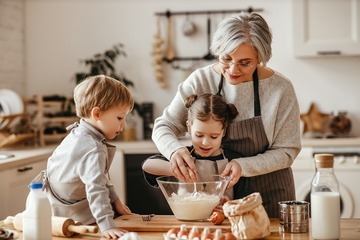 happy family grandmother and grandchildren cook in the kitchen