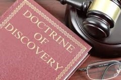 Photo of a gavel, glasses and a book titled "Doctrine of Discovery."