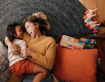 Top view of a mother and her daughter laughing cheerfully
