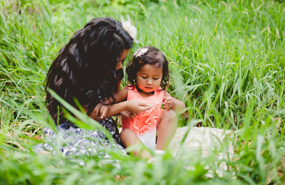 photo of two little girls sitting on the grass