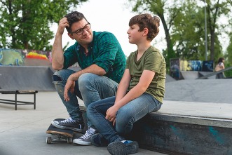 dad with son at skate park