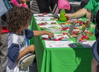 child at a booth grabbing candy