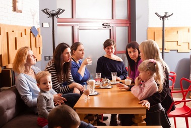 Women and children having food and drinks at a coffee shop