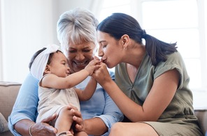 Love, relax and baby with mother and grandma in living room for playing and bonding together. 