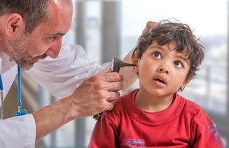ENT medical examination with the otoscope, in one child boy