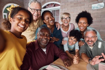 grandparents, parents, kids, and grandkids taking a selfie outside