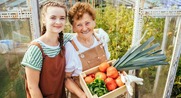 Young lady stands with older adult.