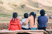 Four children sit in a row looking out ahead.