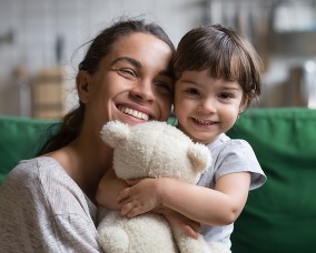 mom and daughter smiling and hugging