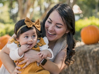 Portrait of a brunette latin mom and her daughter at the farm