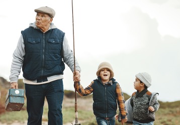 Grandparents, mom and excited children walking at beach or lake on winter holiday adventure in nature.