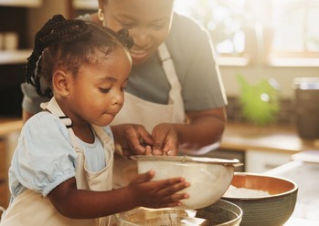 Learning, child and black woman in kitchen for baking, recipe or cake ingredients at home.