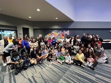 Large group of people gathering inside room.
