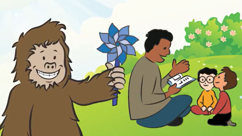 sasquatch with pinwheel smiling, adult male and children reading in the background