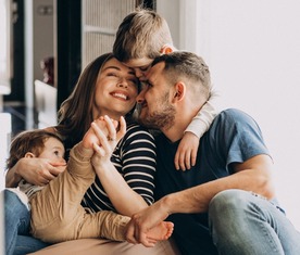 Young family with their sons at home having fun