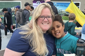 mother and child smiling while sitting at table outside